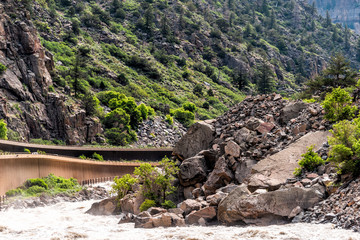 Glenwood Springs Canyon on highway through Colorado towns with cliffs and road by river water
