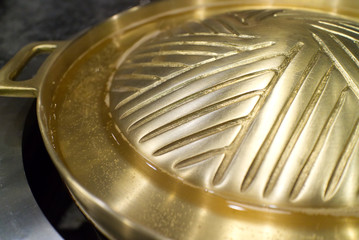 Close up of brass bbq grill plate that can apply to cook either shabu or sukiyaki, Kitchenware