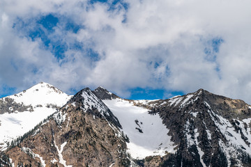 Fototapeta na wymiar Kebler Pass snow peak mountain view with rocky cliff closeup in early summer of 2019
