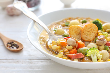 Tasty soup with legumes in bowl on table