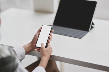 Cropped view of businesswoman holding blank screen smartphone