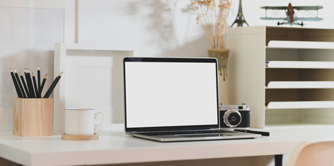 Creative photographer workplace with blank screen laptop