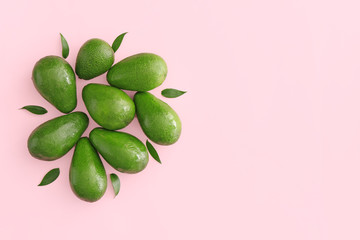 Fresh ripe avocados on color background