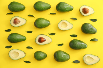 Fresh ripe avocados on color background