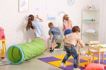 Cute little children playing in kindergarten