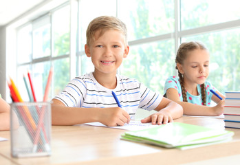 Pupils passing school test in classroom