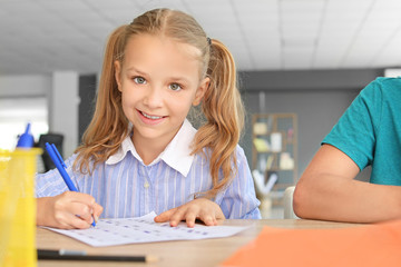Pupils passing school test in classroom