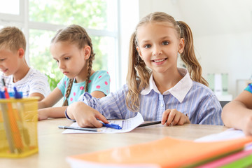 Pupils passing school test in classroom