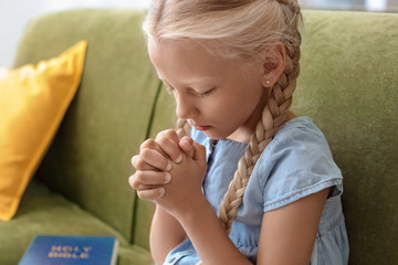 Little girl praying at home