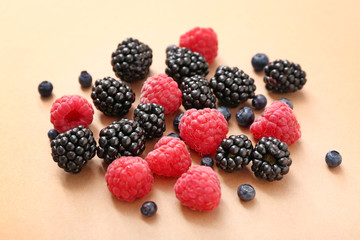 Ripe sweet berries on color background