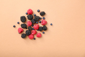 Ripe sweet berries on color background