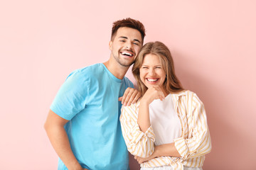 Portrait of happy couple on color background