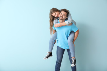 Happy young couple having fun on color background