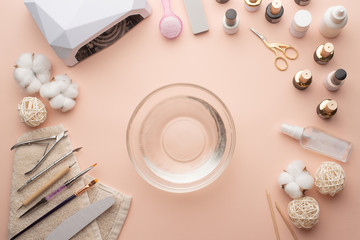 The concept of nail art. Woman gives herself a manicure on a white table, wow behind the nails,...