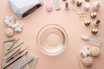 The concept of nail art. Woman gives herself a manicure on a white table, wow behind the nails, close-up. care for the nails