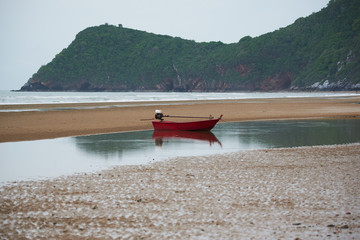 A red fisherman boat on the beach