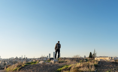 a man standing on mountain top looking clear sky in Jordan