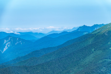 Layers of mountains in the haze and fog.