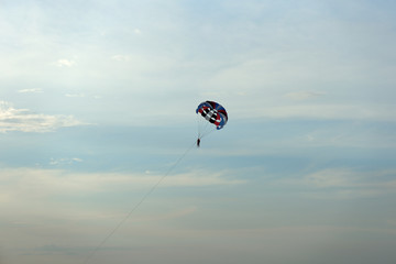 Parasailing on the background of the evening sky. Water activities on the coast of Vietnam