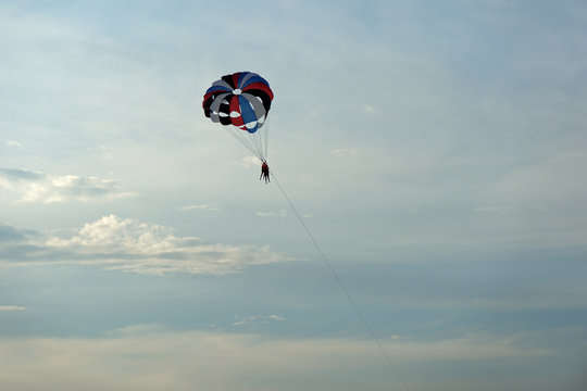 Parasailing on the background of the evening sky. Water activities on the coast of Vietnam