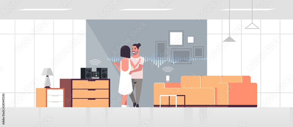 Poster couple using hi-fi stereo system controlled by smart speaker voice recognition activated digital ass