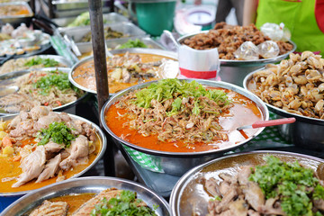 Various of thai curry dishes menu in Big Stainless bowl at thai market