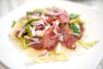 spicy chinese sausage salad on white plate