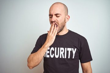 Young safeguard man wearing security uniform over isolated background bored yawning tired covering mouth with hand. Restless and sleepiness.