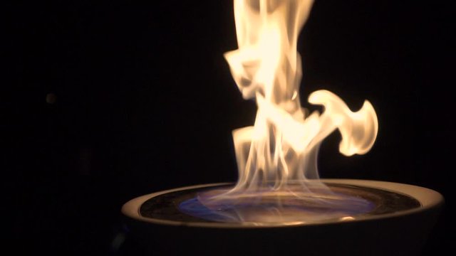 orbiting close up slow motion shot of a fire chalice on a wedding