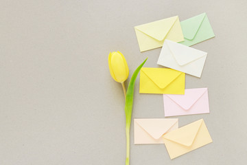 Colorful envelopes on grey paper background, copy space.