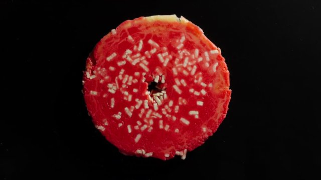 Crush The Colourful Donut On A Black Background
