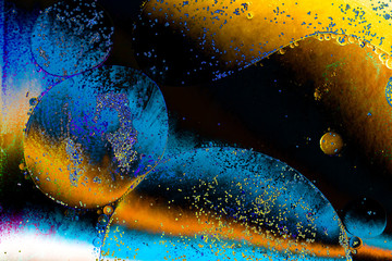 Macro shot of water oil emulsion over colored background