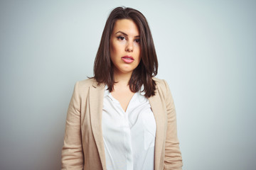 Obraz premium Young beautiful elegant business woman over isolated background with serious expression on face. Simple and natural looking at the camera.