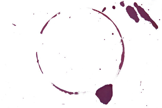A purple, spilled red wine circle is shown isolated up close on a solid, white background.