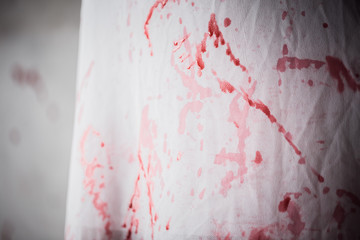 Violence and cruelty, bloody white cloth. Fear of young woman was attacked by a murderer.