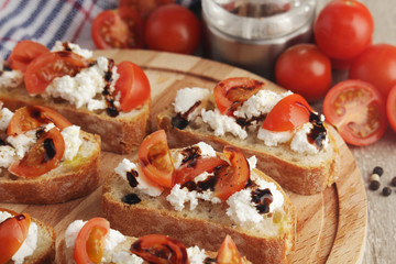 Sandwiches with tomatoes, homemade cheese, olive oil and balsamic sauce