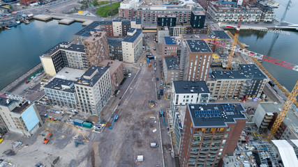 Construction site background. Hoisting cranes and new multi-storey buildings at day time....