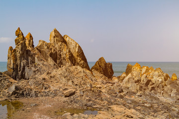 Fototapeta na wymiar Huge rocks on the seashore in India, GOA. Beautiful summer landscape. Travel concept, toned with sunlight.