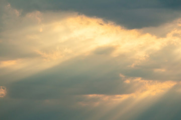 Dramatic picturesque colorful skies with cloud and picturesque sunbeams before sunset