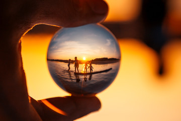 bathing children are reflected in a crystal ball
