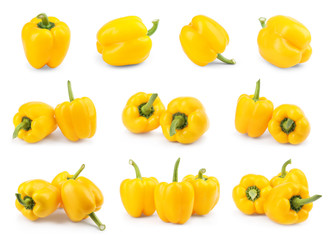 Set of ripe yellow bell peppers on white background