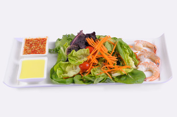 Green salad with shrimps on white background