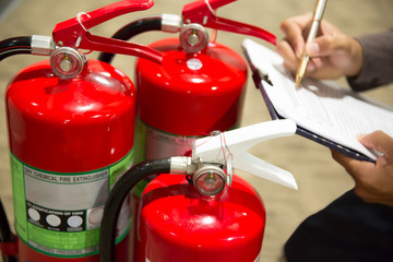 Engineers are checking fire extinguishers.