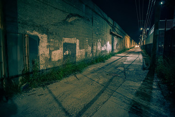 Dark and eerie urban city alley at night 