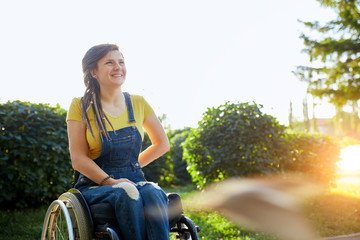 beautiful disabled girl looking up, looking at the bright side of life, woman gets pleasure from...