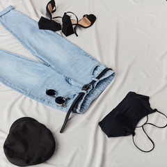 young girl has taken of the clothes and put them on the bed. top view photo.