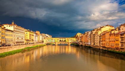 Fototapeta premium View of medieval stone bridge Ponte Vecchio over Arno river in Florence, Tuscany, Italy. Beautiful Florence after the rain. Florence architecture and landmark.