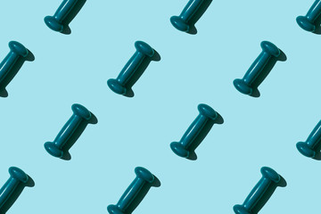 Turquoise dumbbell pattern on blue background. Creative sports layout.