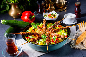 Lamb skewers with curry rice and different vegetables