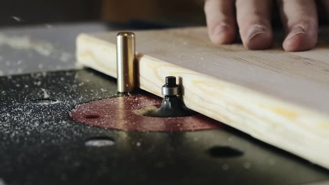Removing an edge from a tree using a milling machine. Close-up. Slow motion.